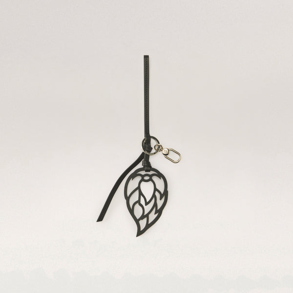 Shop the Signature Seed Logo Leather Charm in Black | Helen Kaminski